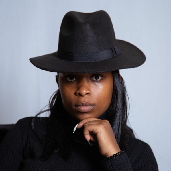 black woman wearing men's hat