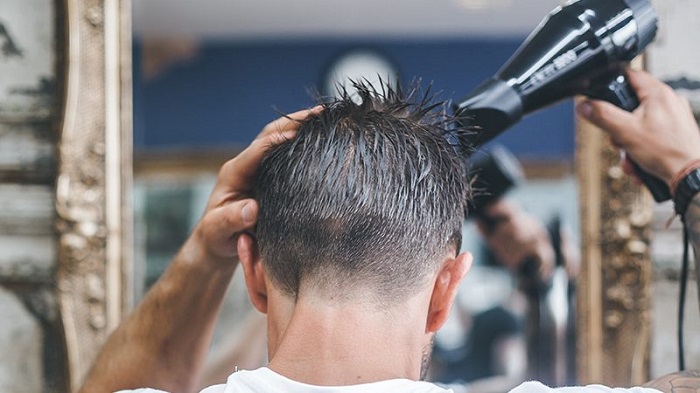 man using hairdryer