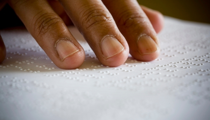 a man reading Braille