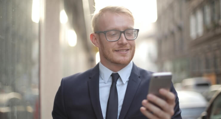 a man in a suit looking at his phone
