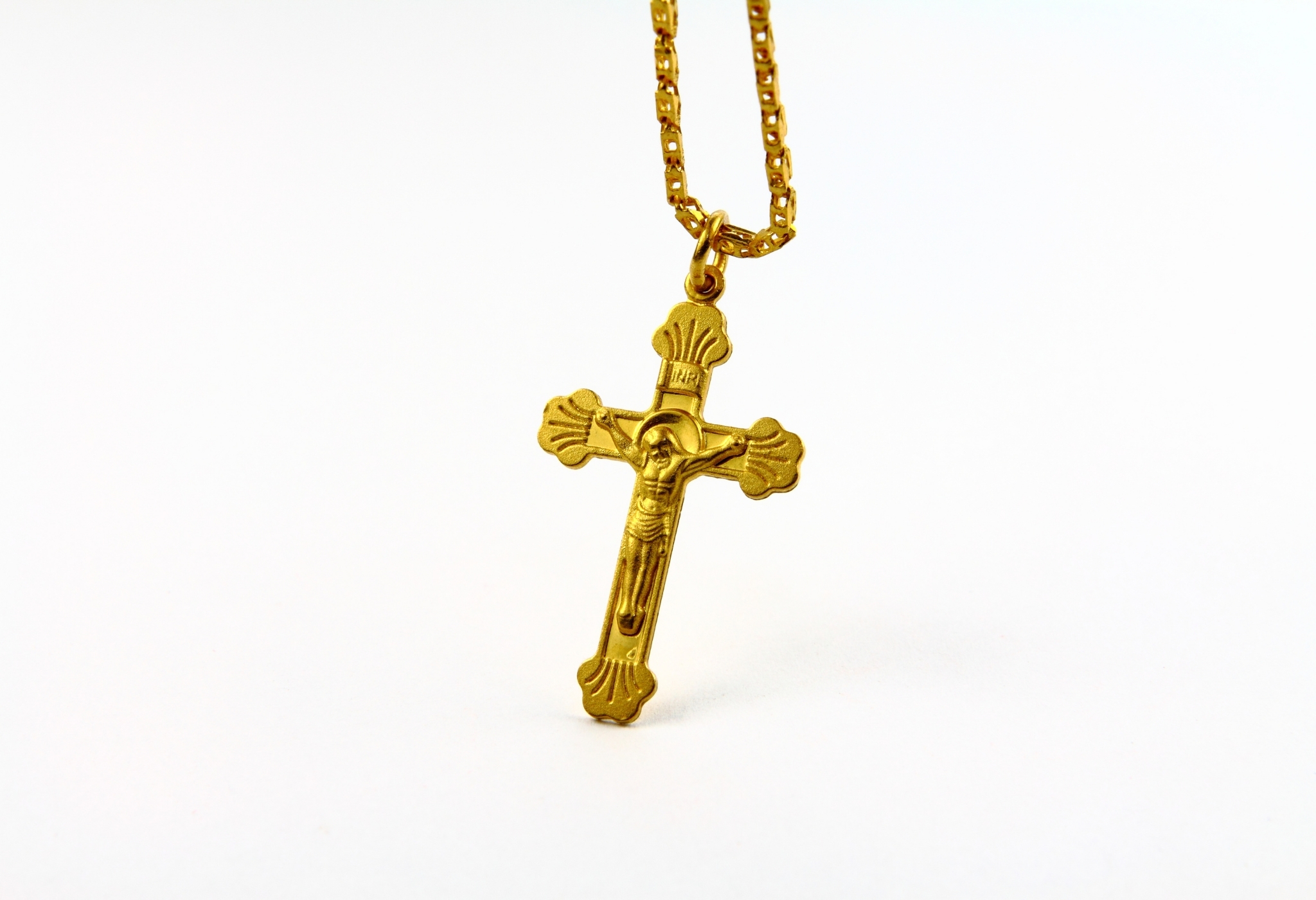 Religiöse Anhänger wie ein goldenes Kreuz sind die Art und Weise, wie Männer Halsketten tragen