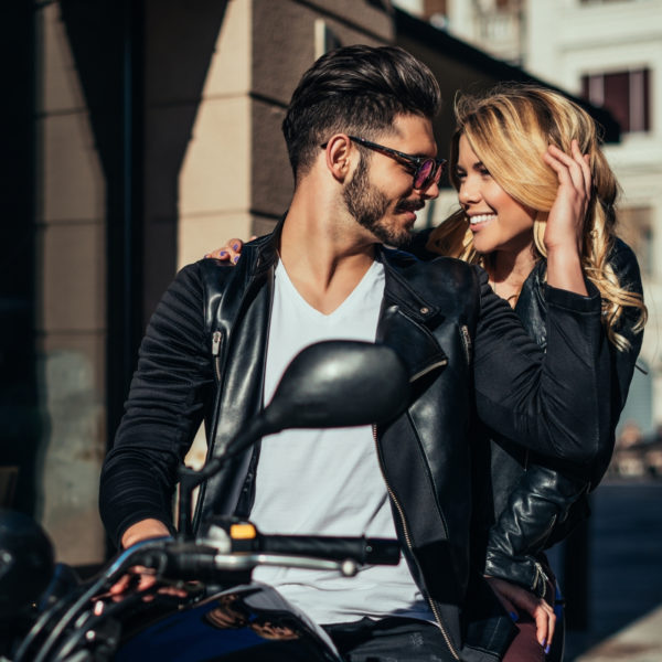 an attractive guy on a motorbike with a woman