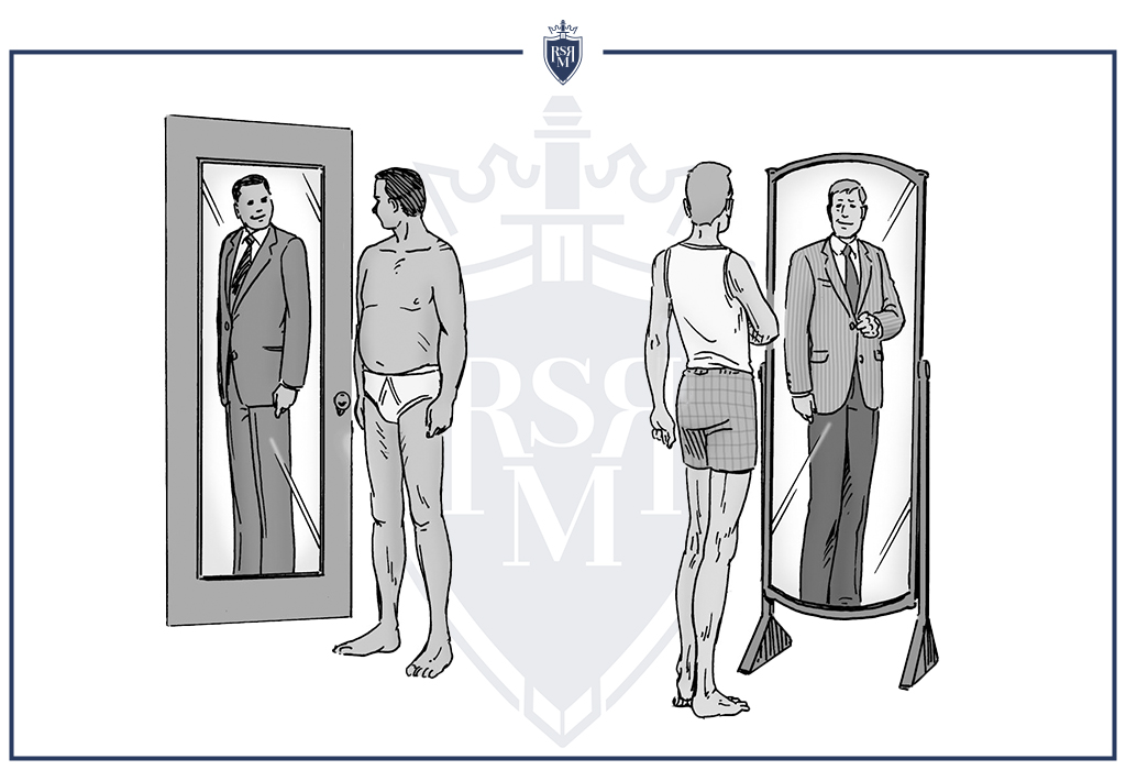 men checks his appearance looking at the mirror