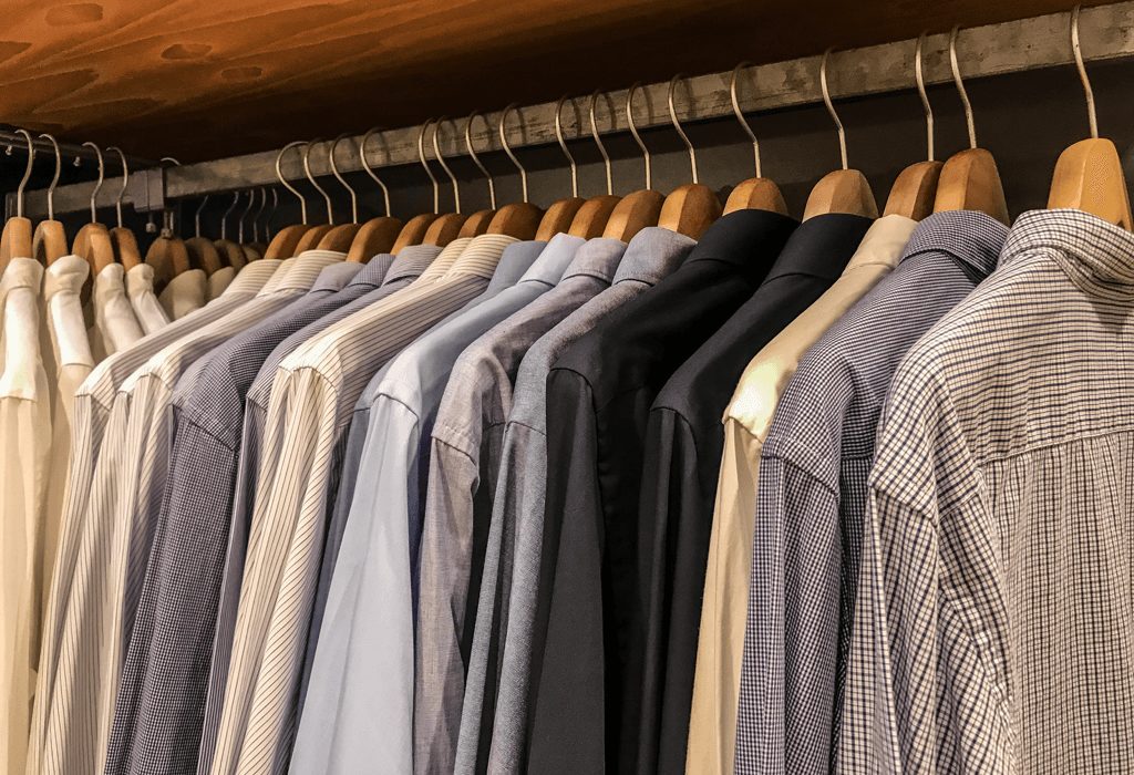 Shirts hanging on wooden hangers is a great clothing hack for guys 
