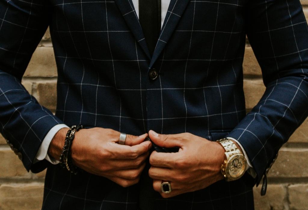 man wearing rings and suit
