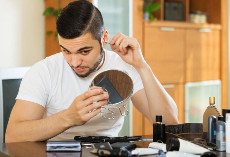 man grooming ear hair