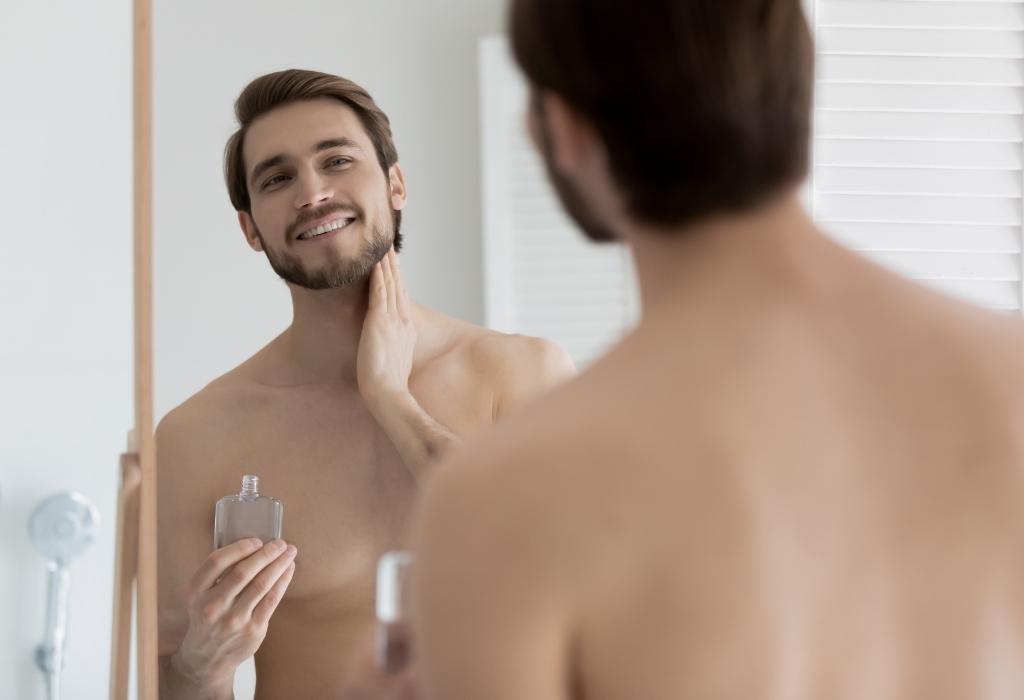 man applying aftershave