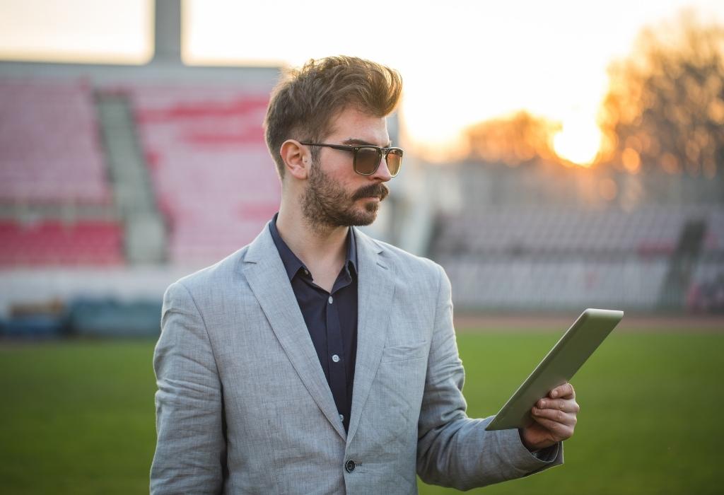 man wearing sports coat on pitch