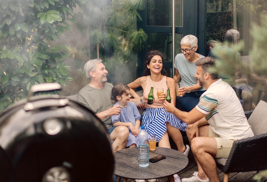 family laughing with drinks and grill 