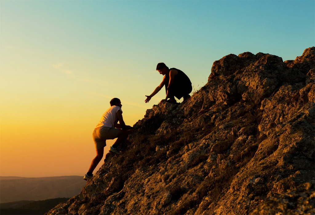 two men climbing a mountain
