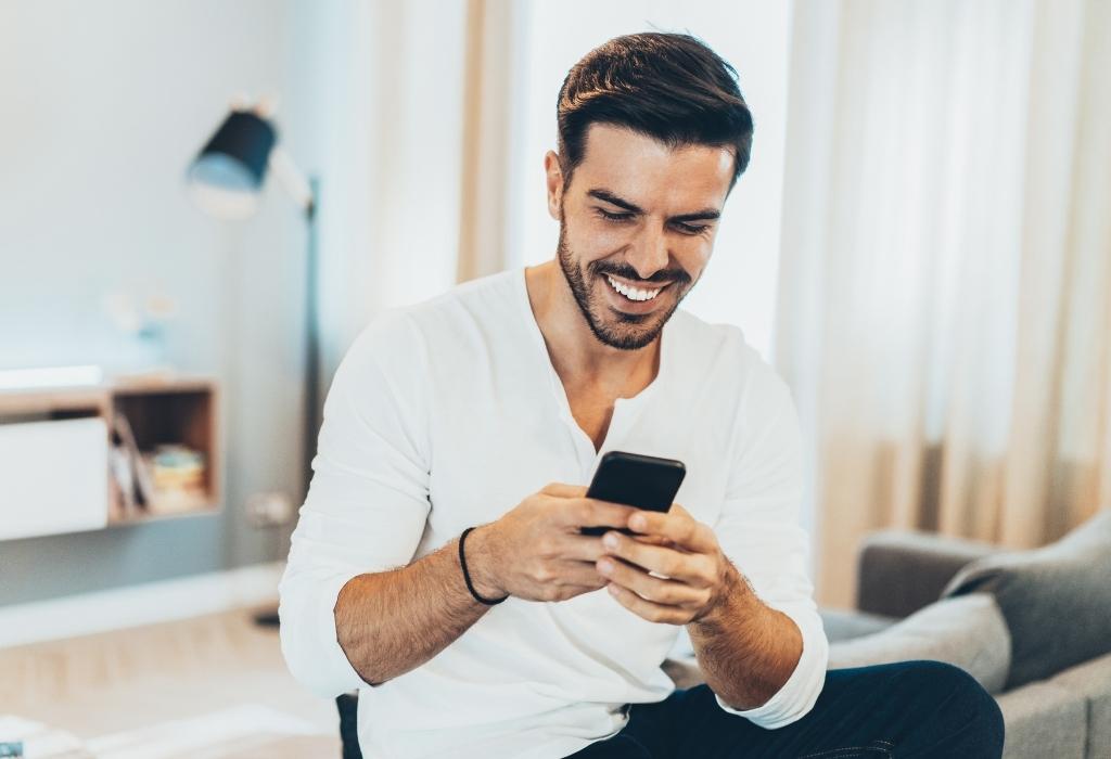man texting and smiling 