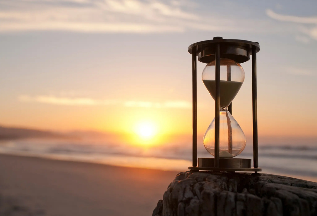 hourglass on a sunset beach