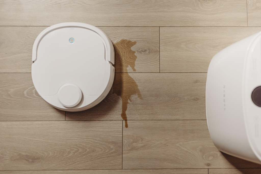 robot vacuuming floor with spilled coffee