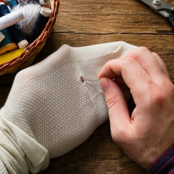 man sewing sock
