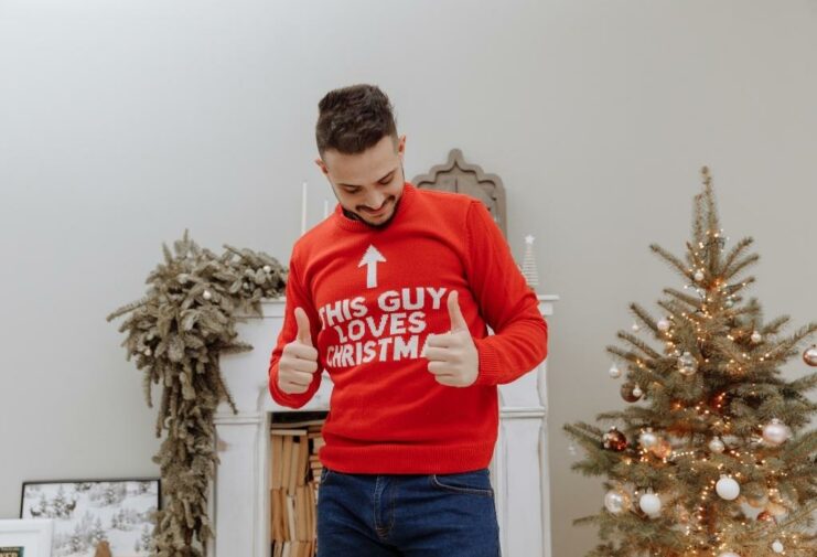 Man wearing slogan Christmas sweater