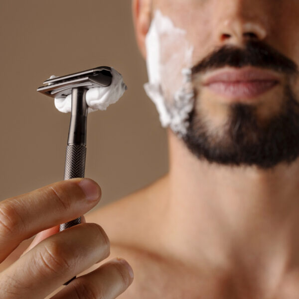 front-view-man-holding-shaving-razor