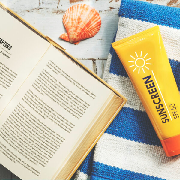 sunscreen-sunglasses-towel-book-recess-relax-concept