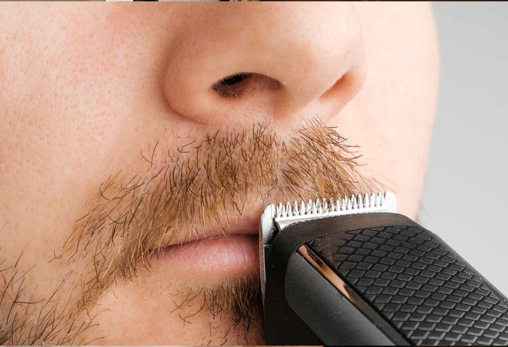man shaving moustache