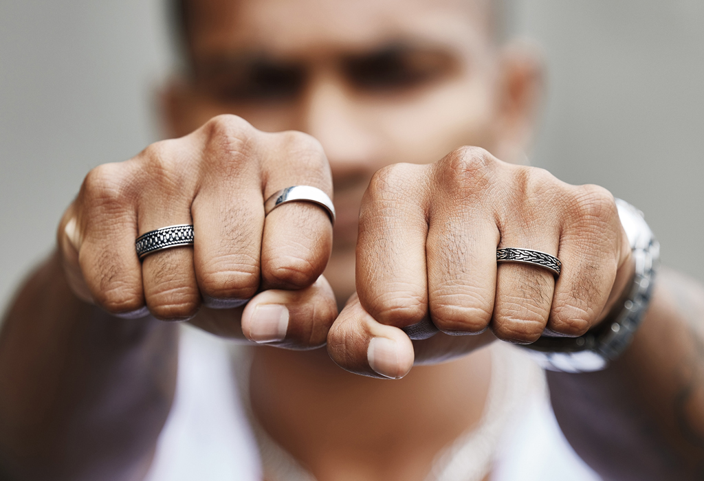 man wearing multiple rings on both hands